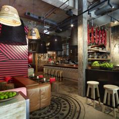 Aztec-like circular motifs feature underfoot, and both wall and floor decorations are hand-painted. There’s an overall roughness to the place from the brick, breeze block table supports and huge logs employed as seats...