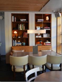 Dining room at Hotel Centennial, Woollahra. You immediately feel at home when a dining area is warm and cosy with a selection of coffee table books.