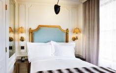 
                    
                        The Marlton Hotel New York // Bedroom with gilded accents.
                    
                