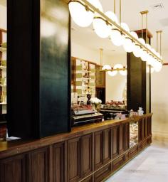 
                    
                        With its high-gloss painted wood shelves, walnut bar, and travertine-clad floor, this outpost of Stumptown Coffee Roasters recalls a '20s speakeasy.
                    
                