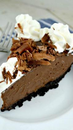 Decadent Chocolate Cream Pie enhanced with a generous splash of rum set in a yummy chocolate crumb crust and topped with chocolate curls and just a bit of rum spiked homemade whipped cream #delicious #recipe #cake #desserts #dessertrecipes #yummy #delicious #food #sweet