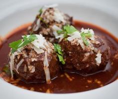 
                    
                        Oaxacan albóndigas en adobo are the staple at Comal in Berkeley, CA. A blend of pork and beef, plus ricotta, pecorino, panko, and eggs in a spicy, smoky ancho chile broth—have San Franciscans flocking to the East Bay.
                    
                