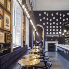 
                    
                        The venue also takes inspiration from Pennethorne’s travels in aesthetics and cuisine. Italian marble counters and a pair of marble fireplace surrounds speak to Pennethorne’s formative experiences, as does the wall decorated with plaster cameos of the architect and the numerous gilt-framed sketches of classical architecture...
                    
                