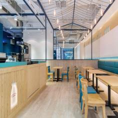 
                    
                        Over-decoration got the elbow, and instead the pair went down the minimalist route, weaving in dairy farm motifs such as milk bottles patterned on the walls and hanging overhead as light fittings. The bottles seem to drip condensation onto the surface below, and the organic feel of the venue is palpable...
                    
                