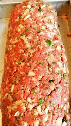 Uptown Meatloaf Recipe ~ The meatloaf that went viral, It'll knock your socks off!... this is a combination of sirloin roast & pork shoulder freshly ground with dried fennel seeds. And added fresh herbs, eggs, soft ciabatta crumbs, garlic and onion. Spread it out on a baking sheet, covered it with plump sun-dried tomatoes, fresh basil & thick slices of creamy mozzarella then rolled it up.