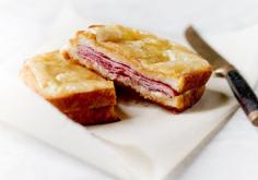 Good croque-monsieurs have a few things in common: a single layer of French ham and Gruyere pressed between two thin slices of bread. Some, like this one, are filled and topped with béchamel, which makes the whole thing creamier and better. It should be rich, substantial and salty, so you will reach for a glass of wine or beer between bites.