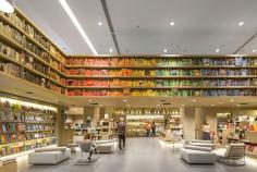 
                    
                        Studio Arthur Casas crafted a colorful, four-story outpost for Brazilian bookseller Saraiva. The double-height first level is bordered by a rainbow of books arranged on warm walnut shelves, and seating options by Brazilian designers such as Sérgio Rodrigues offer pleasant spots to read.
                    
                