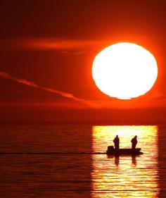 
                    
                        Two fishermen trawl at sunset on a small boat at Frankston Foreshore on June 21, 2015 in Melbourne, Australia.
                    
                