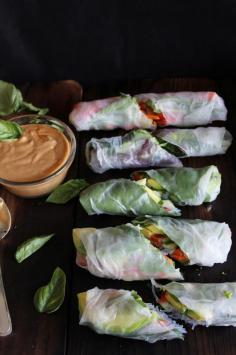 This Rawsome Vegan Life: fresh summer rolls with basil, avocado, kale + spicy garlic Peanut sauce: 2 garlic cloves, minced 1 tablespoon chunk of ginger, peeled and finely chopped 2 tablespoons each of tamari, maple syrup, and lime juice Chili powder, to taste 1/3 cup peanut butter 1/3 cup water (more or less as needed) 1 cup cooked vermicelli (AKA rice noodles) 5-8 rice paper sheets 1 carrot 1 avocado 1/3 cucumber 1 cup fresh basil 1/2 cup cilantro 5-8 kale leaves 1/2 red pepper