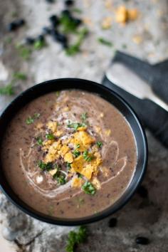 Spicy black bean soup with sour cream and crushed nachos on top.  Swap the sour cream for greek yogurt to make it even healthier. Recipe below photo. egle ma https://www.flickr.com/photos/egle_aleks/6750313289/in/photostream/ #blackbeansoup #blackbeans #spicysoup #hispanicfood