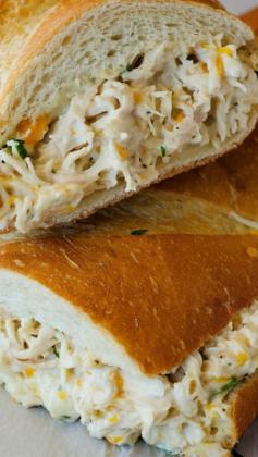 Chicken Stuffed French Bread | 1 loaf french bread 1 pound chicken breasts, cooked and shredded 1 1/2 cups Colby-Jack cheese, shredded 2 green onions, sliced thin 1 to 2 cups Ranch dressing Instructions Preheat oven to 375° F. Line a large baking sheet with parchment or wax paper. Slice the french bread in half lengthwise. Place both halves cut side up on prepared baking sheet. In a large bowl, mix together shredded chicken, cheese, green onions and enough