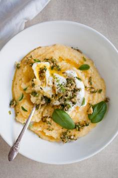 For the pesto:  * 1/3 cup olive oil  * 1/2 cup green olives, coarsely chopped  * 1 cup fresh Italian parsley or basil, coarsely chopped (I used basil)  * 1/2 cup fresh oregano, coarsely chopped  * 1/2 cup fresh thyme, coarsely chopped  * Mix olives and fresh herbs in a medium-sized bowl. Stir in olive oil and season with salt and pepper. Mix until homogenous. Set aside.    For the polenta:  * 2 cups polenta  * 8 cups water (depending on how thick you like your polenta)  * 1/2 cup hard cheese, shredded (Parmesan or Grueyere are both great for this)  * 3/4 teaspoon salt  * Heat water in a large pot, when boiling, slowly pour in polenta. Lower the temperature to simmer and cook for about 20-25 minutes, until polenta has absorbed the water. Take pot off flame and stir in shredded cheese and salt. Season with salt and pepper. Cover and set aside until plating.    For the poached eggs:  * 4 eggs  * 1 teaspoon lightly-colored vinegar (any type will do, just not balsamic as it will color the eggs)  * salt  * Crack eggs into a small bowl, set aside. Heat another medium-sized pot with water, adding a sprinkle of salt and teaspoon of vinegar to water. When water is at a boil, slip the four eggs into the water bath, swirling with a spoon to help eggs form into solid shapes. Cook for about four minutes for a slightly runny center.    How to assemble the dish:  * ladle about 1 1/2 cups of the polenta into a large bowl, add an egg to each bowl, garnish with the olive-herb pesto. Serve with extra olive oil and lots of salt and pepper.    Recipe from The Kitchn