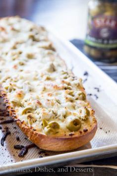 
                    
                        Garlic Olive Cheese Bread - take you garlic bread and turn it up a notch!  Top it with Basil & Garlic flavored olives and lots of cheese!
                    
                